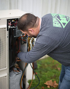 Boyd Service Company technician working on an outdoor commercial air conditioning unit.